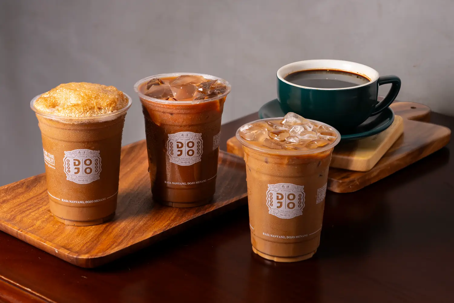 Nanyang kopi hot and iced in DOJO cups on a wooden tray