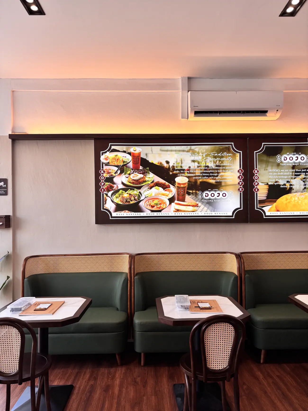 Green booths and marble tables inside DOJO Papar