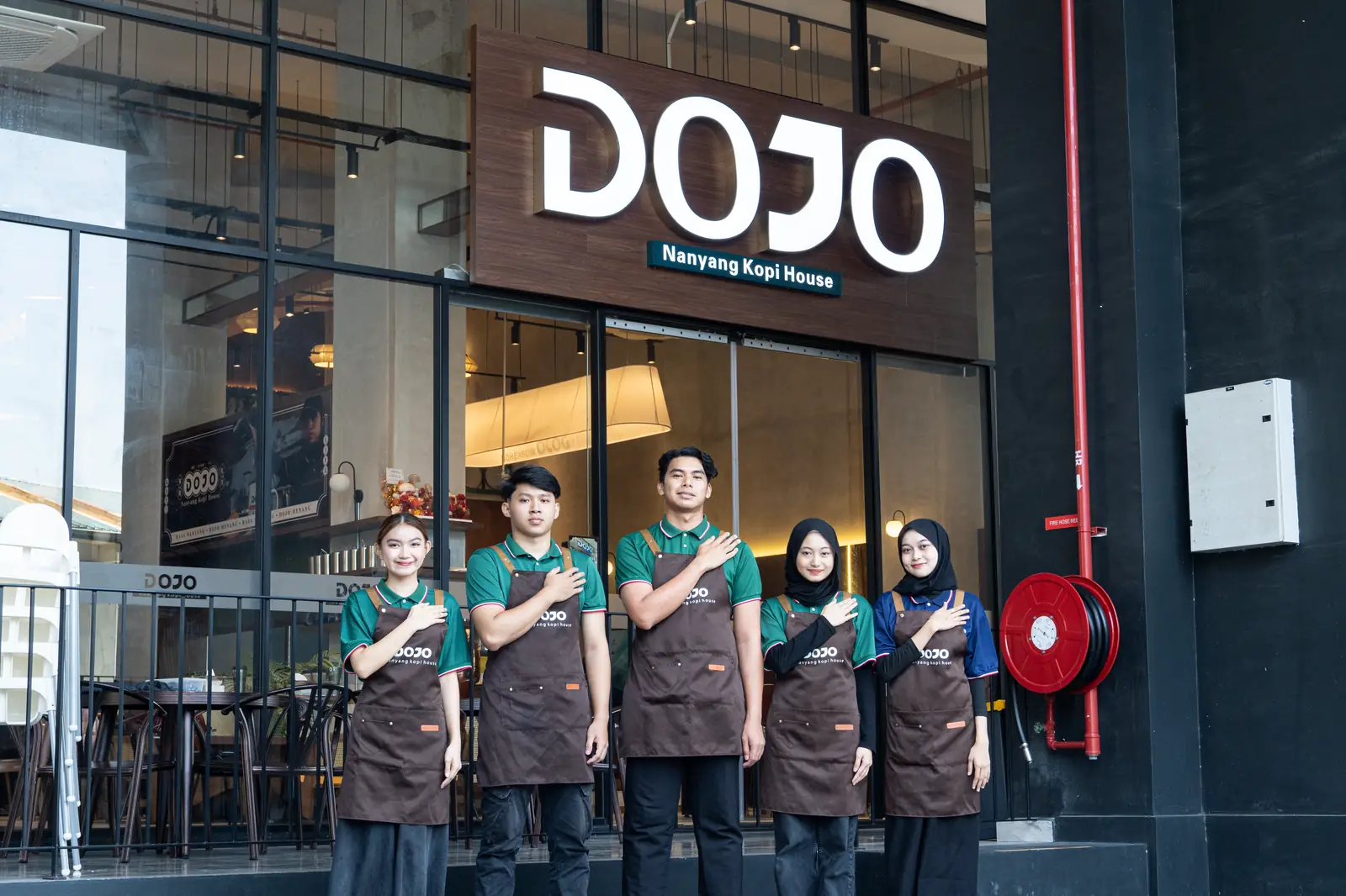 The DOJO team in aprons outside a DOJO Nanyang Kopi House